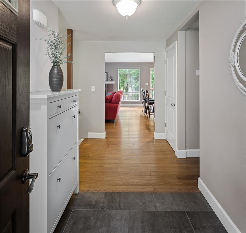 Beautiful tile entry leads to gorgeous hardwood floor throughout the kitchen & living areas