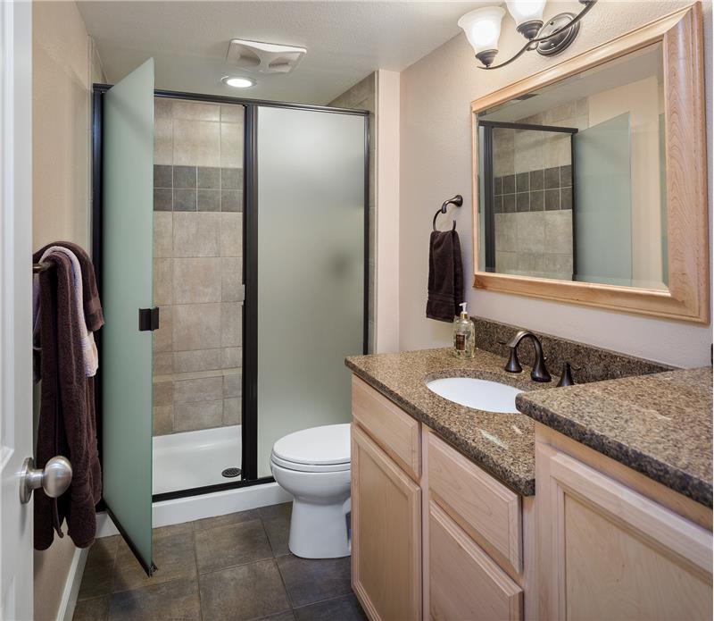 The 3/4 Bath on the lower level features radiant heat tile flooring and fully tiled shower