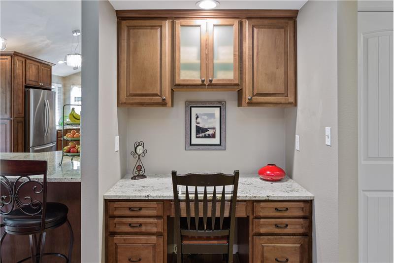 This built in study-nook adjacent the kitchen and living room is convenient for homework nights and provides useful storage