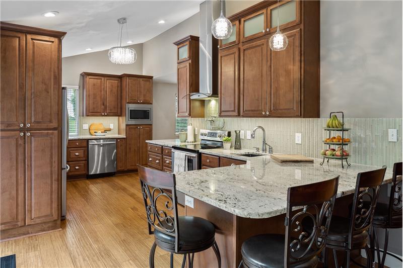 Wonderfully updated kitchen with eating area opens to the living room and features maple cabinets, & granite countertops