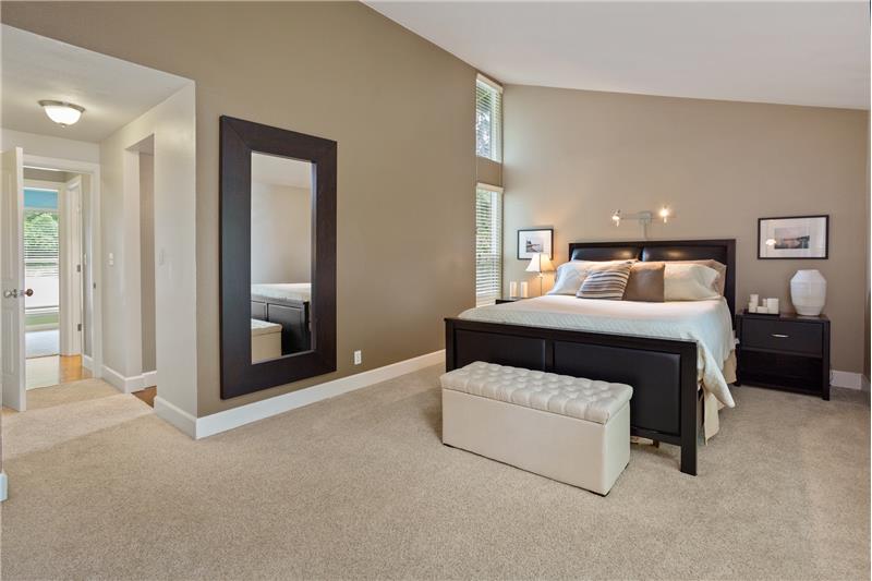 Spacious master suite with vaulted ceilings, his & hers closets, and en-suite 3/4 bath