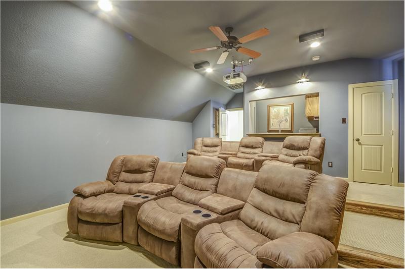 Media room with stadium seating, wet bar and media equipment