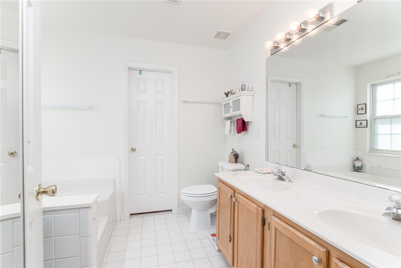 Duel vanities, a soaking tub and separate shower are great added features in the owner's bathroom.