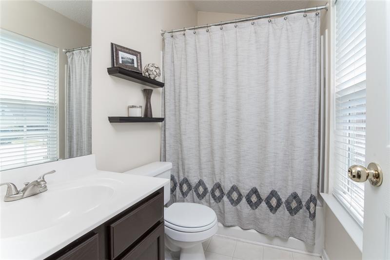 A beautiful hall bathroom is accessible for the extra bedrooms and loft.