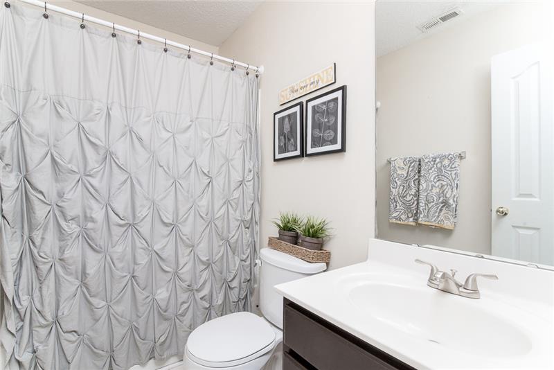 A beautiful en suite bathroom connects to the owner's bedroom.