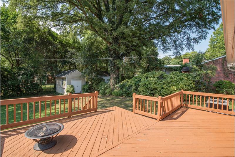 The oversized deck is the perfect place to relax and enjoy the huge shade tree in the backyard.