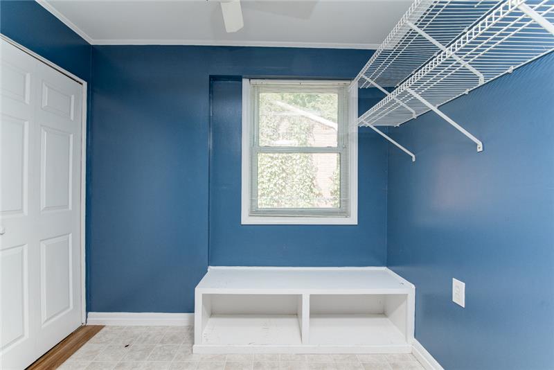 The mudroom/laundry room includes built in storage space!