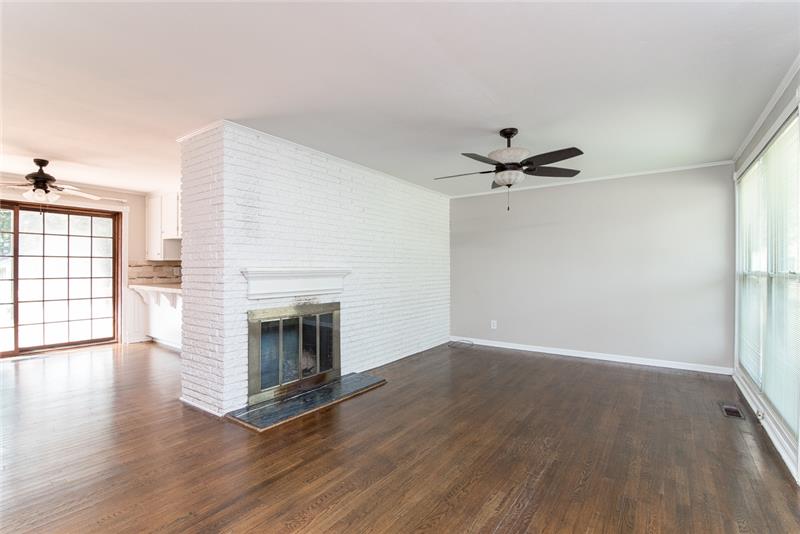 The exposed brick wall and wood burning fireplace give this home tons of character.