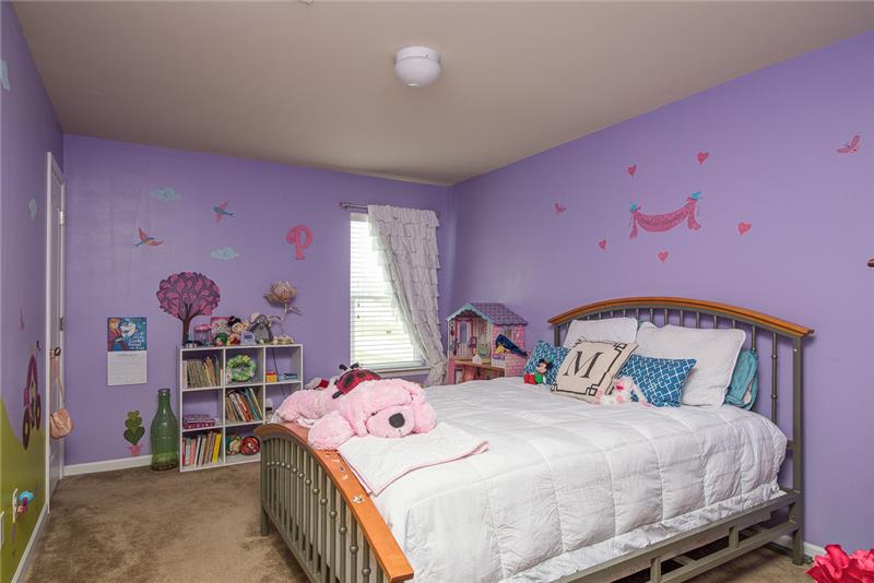 Large secondary bedrooms each have bright windows and spacious closets.