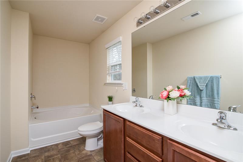 The owners bathroom includes dual vanities and an oversized soaking tub and separate shower.