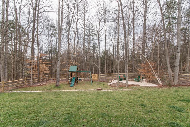 Wooded views and plenty of space to relax abound in this great backyard!