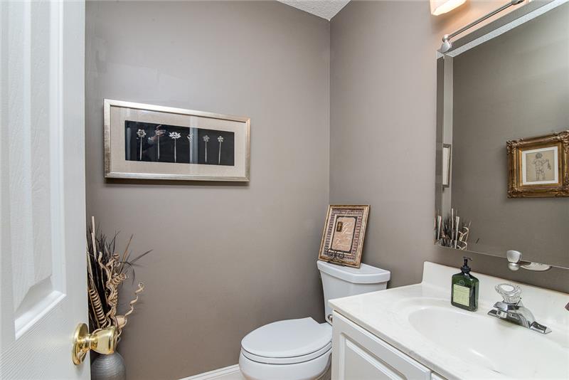 The neutral colors and unique mirror complete this bathroom.