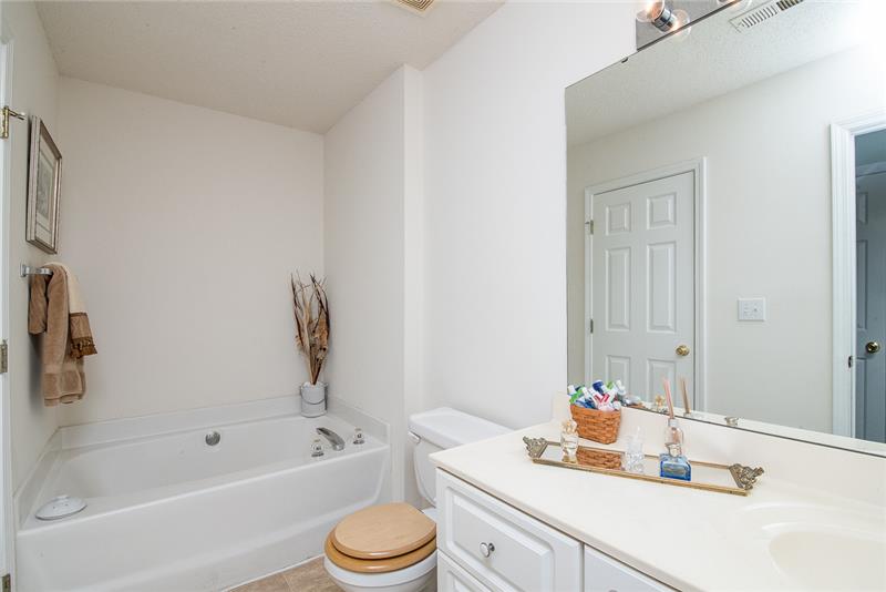 The bathroom upstairs is conveniently accessible by both upstairs bedrooms.
