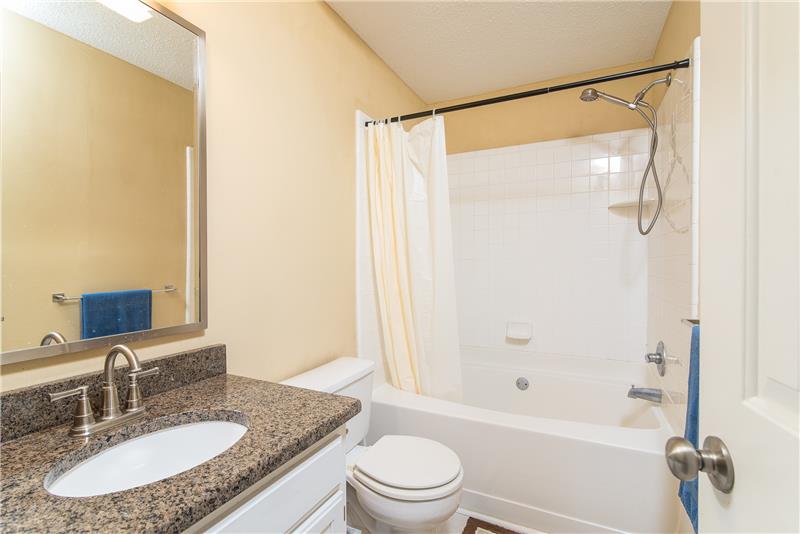 The guest bathroom also includes a granite countertop.