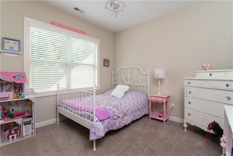 The spacious secondary room includes a double window and generous closet storage space.