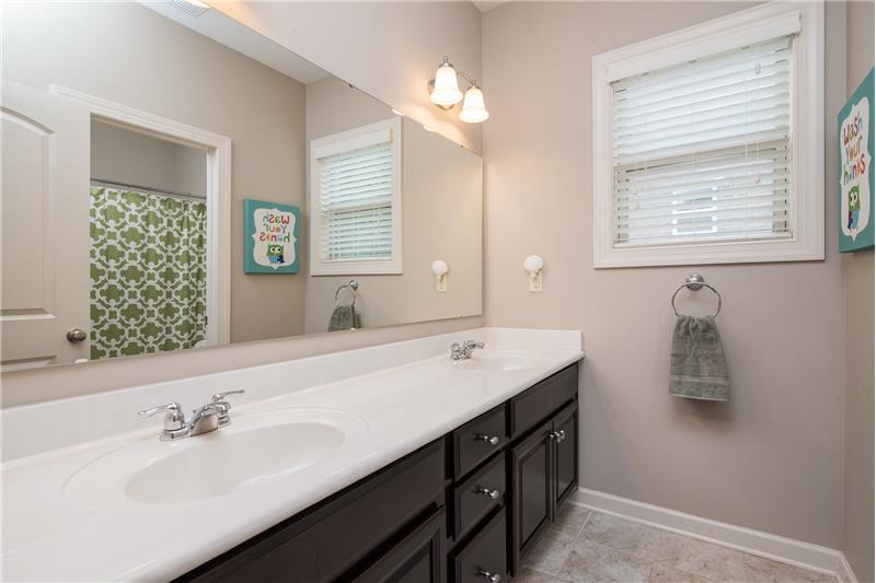 The full bathroom upstairs includes double bowled sinks.