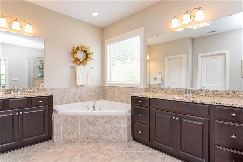 The oversized soaking tub and separate shower are surrounded by beautiful neutral ceramic tile.