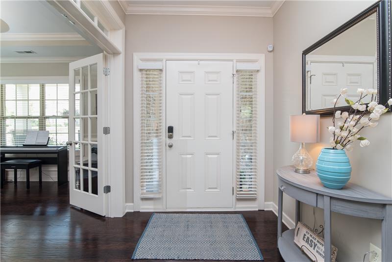 A comfortable rocking chair front porch, side light windows and classy hardwood floors inside make a beautiful entryway.