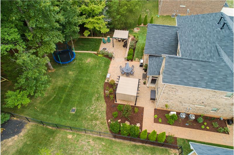 Enjoy the large garden area along the side of the home with a long brick paver patio.
