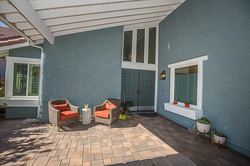 LARGE COVERED PORCH LINED WITH PAVERS