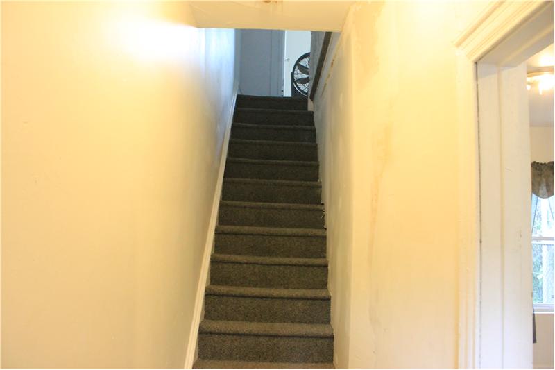 carpeted stairway leading to second floor.