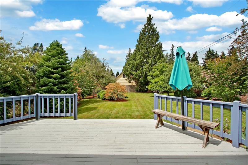 The deck leads to the level and spacious west-facing back yard