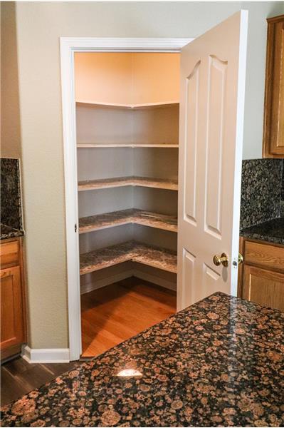 While the kitchen boasts plenty of storage, you'll love this additional pantry closet for your supplies, pots and pans!