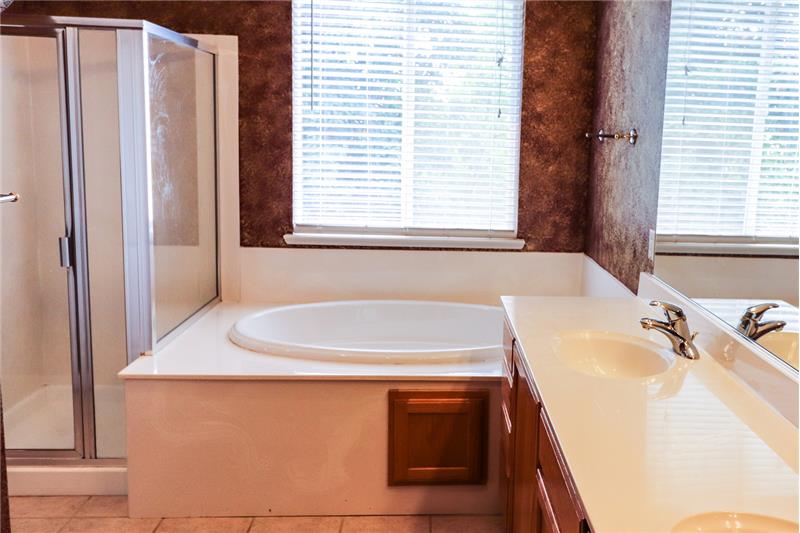 Luxurious master bath has separate oversized tub/ shower, double sinks and linen closet. What a wonderful retreat!