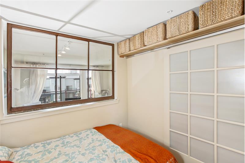Barn door style door closing off bedroom from the kitchen