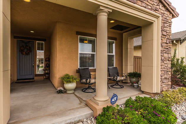 Enjoy the beautiful neighborhood while sitting under the covered porch.