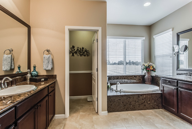 Master bathroom includes double vanities, a large soaker tub, seperate water closet and a generously sized shower with seating.