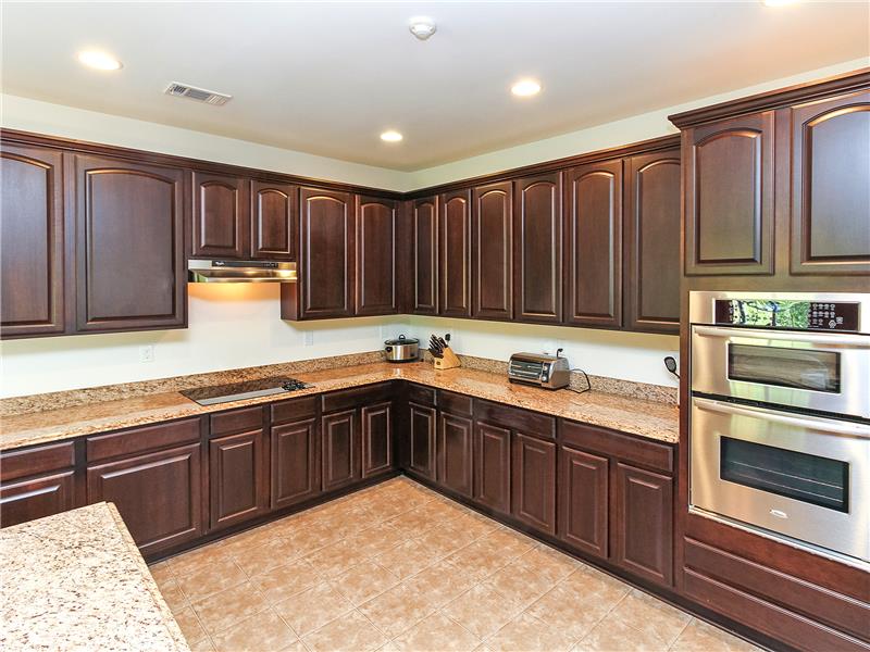 Abundant cabinetry and extensive granite counter tops
