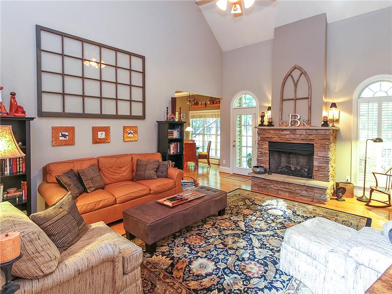 Handsome stone fireplace flanked by Palladian windows