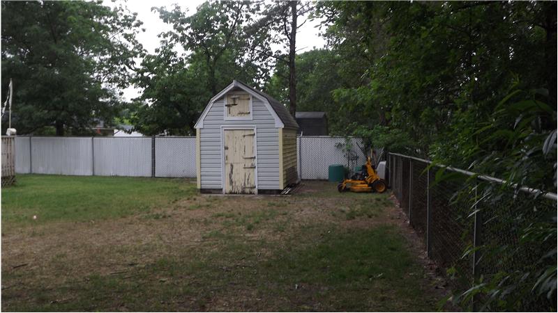 Fully fenced yard and shed for additional storage.