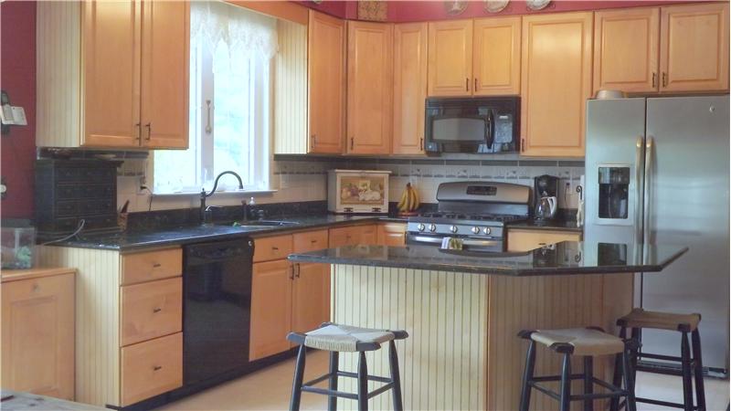 The kitchen features granite counter tops.