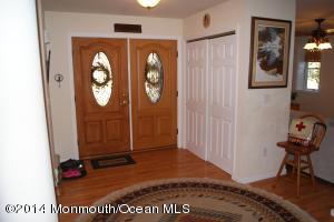 Entry foyer with double doors and coat closet.