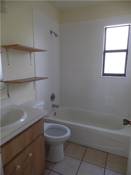 Bathroom with shower/tub combo and window