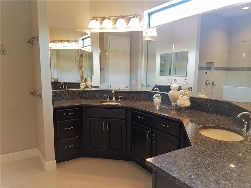 Master Bathroom includes wood cabinetry, double undermount sinks, and granite counters.