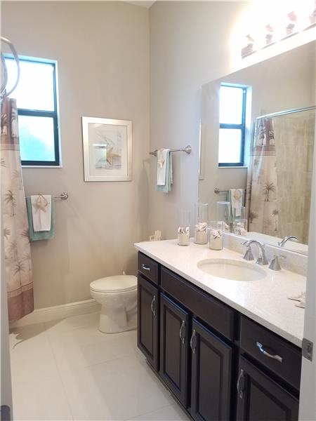 Guest Bath- - features wood cabinetry, Caesarstone counter, and undermount sink.