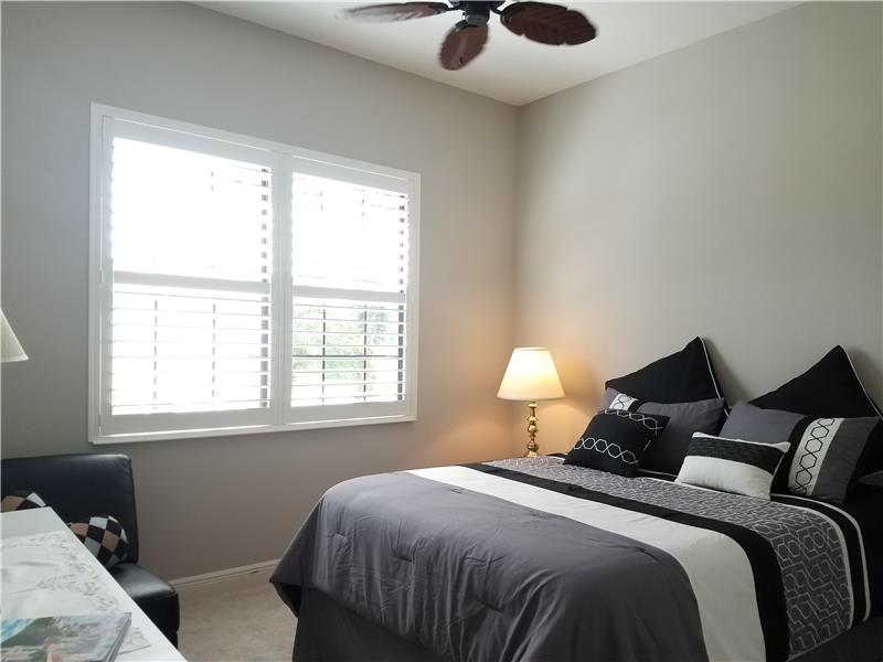 Bedroom #2, All bedrooms are carpeted, have ceiling fans, and plantation shutters.