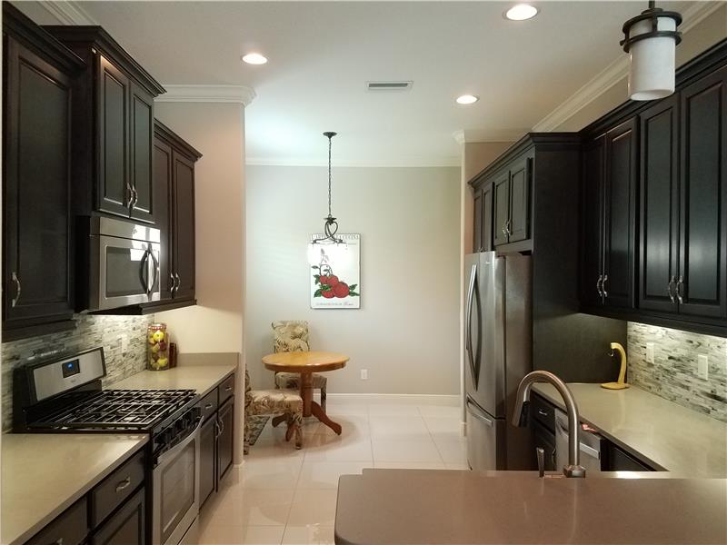 Gourmet eat-in Kitchen is a chef’s dream with gas range, French refrigerator, and stainless steel appliances.