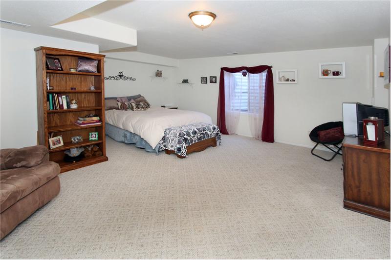 Large third bedroom in basement with sitting area