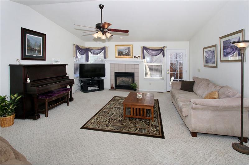 Living room with gas fireplace and vaulted ceilings