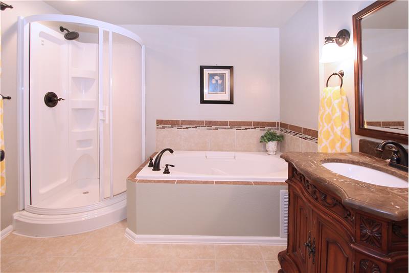 4-piece bath in the basement with tile floors