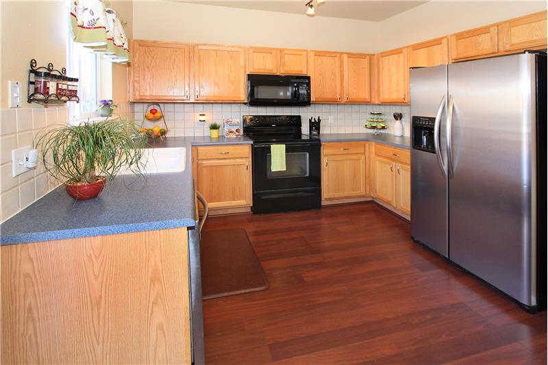 Ample cabinet storage, counter space, and a tile backsplash