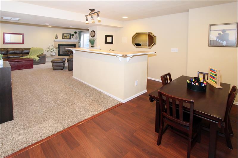 View of the spacious family room and a wet bar in the finished basement
