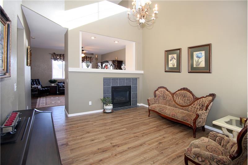 Open living room with vaulted ceilings, 2-sided gas fireplace