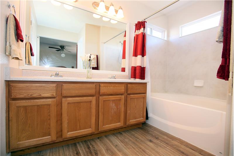 Master Bath with garden tub, double sinks, and a walk in closet