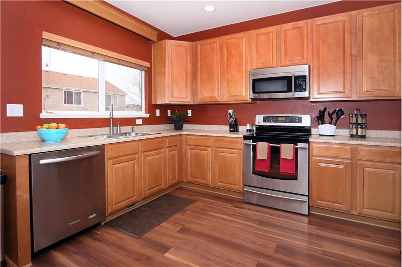 Eat-in kitchen with ample cabinet storage and counter space.