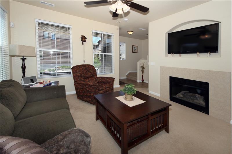 Living room with ceiling fan and gas fireplace
